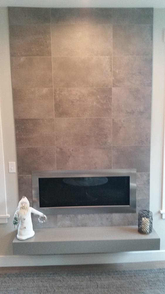 Linear gas insert with custom tile mantle with a granite slab hearth