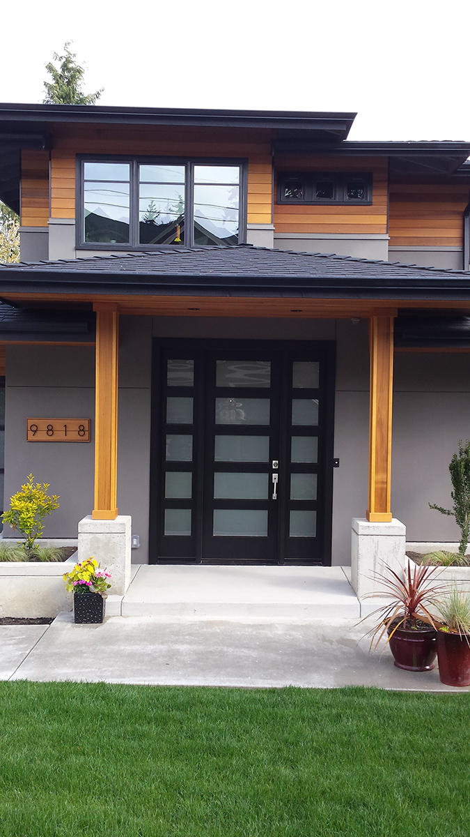 Contemporary entry with clear cedar columns and soffit